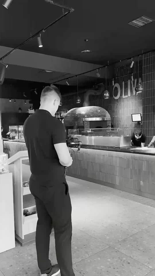 A pizzeria, in black and white